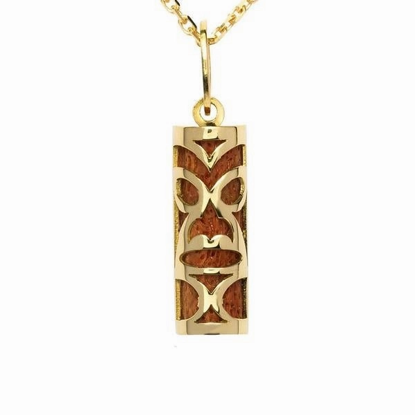 Pendentif tiki chambranle en or jaune. corail rouge du lagon