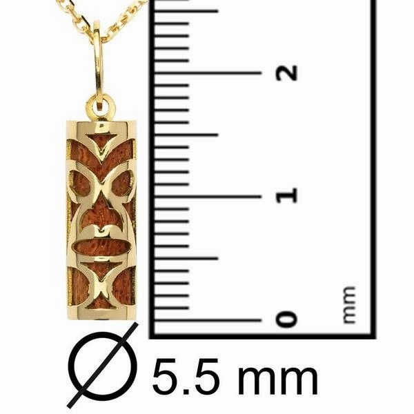 Pendentif tiki chambranle en or jaune. corail rouge du lagon