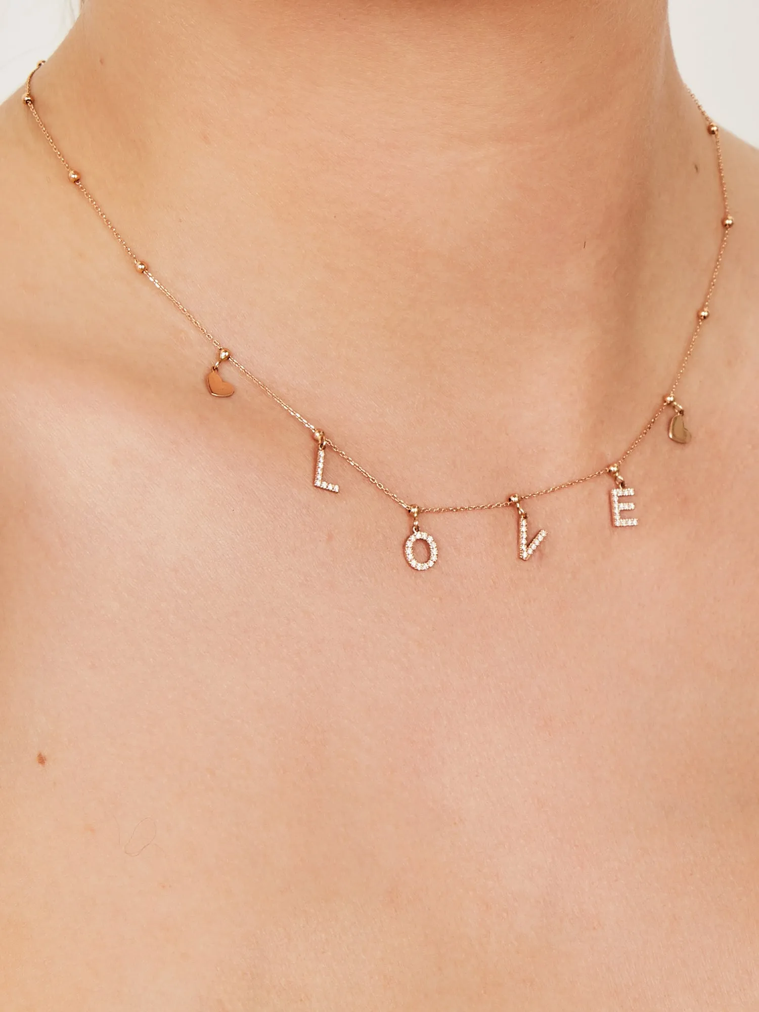 Rose gold necklace with hearts and diamond L-O-V-E pendants