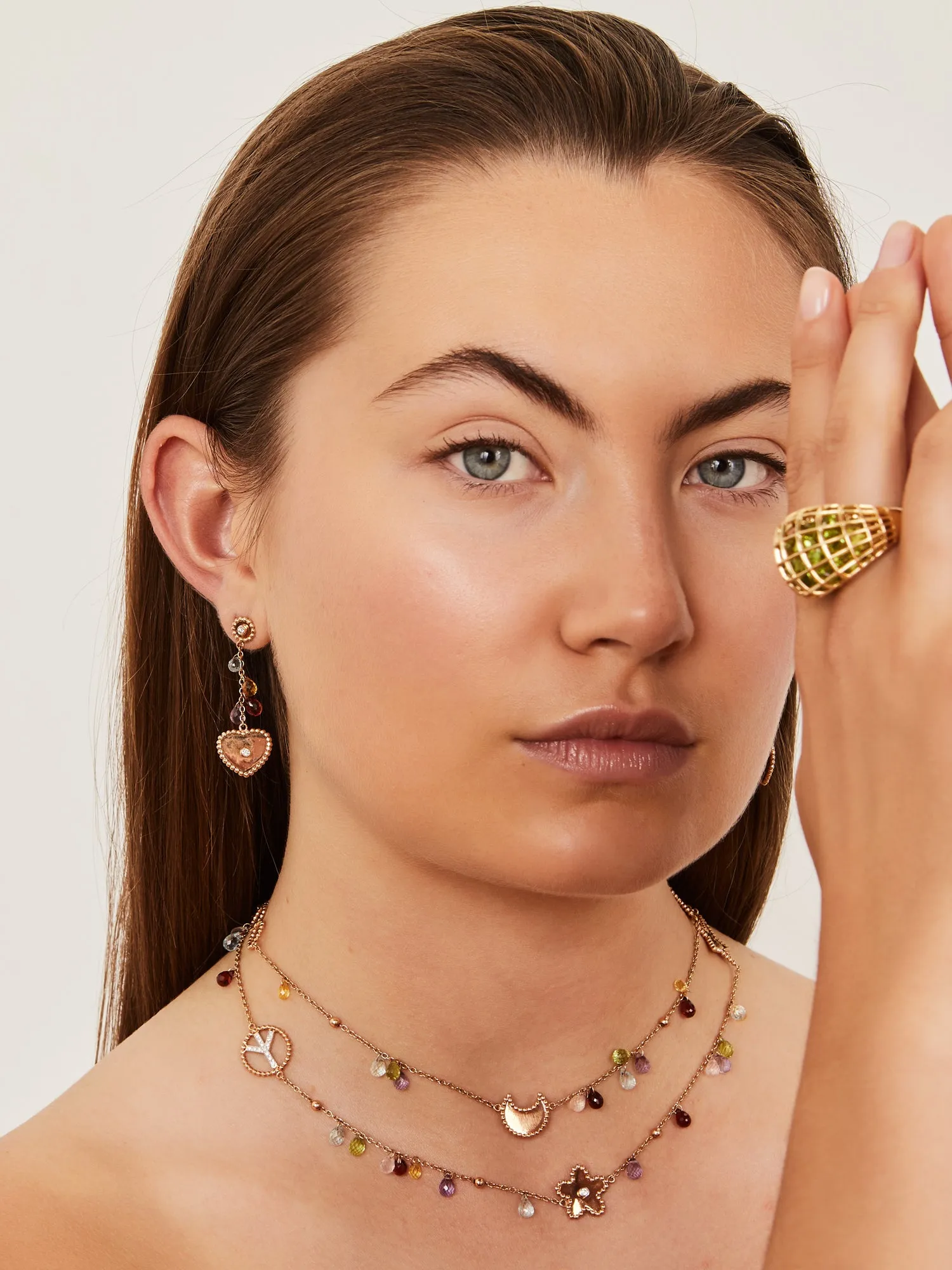 Rose gold necklace with pink gold heart, flower, clover, moon and star, set with gemstones