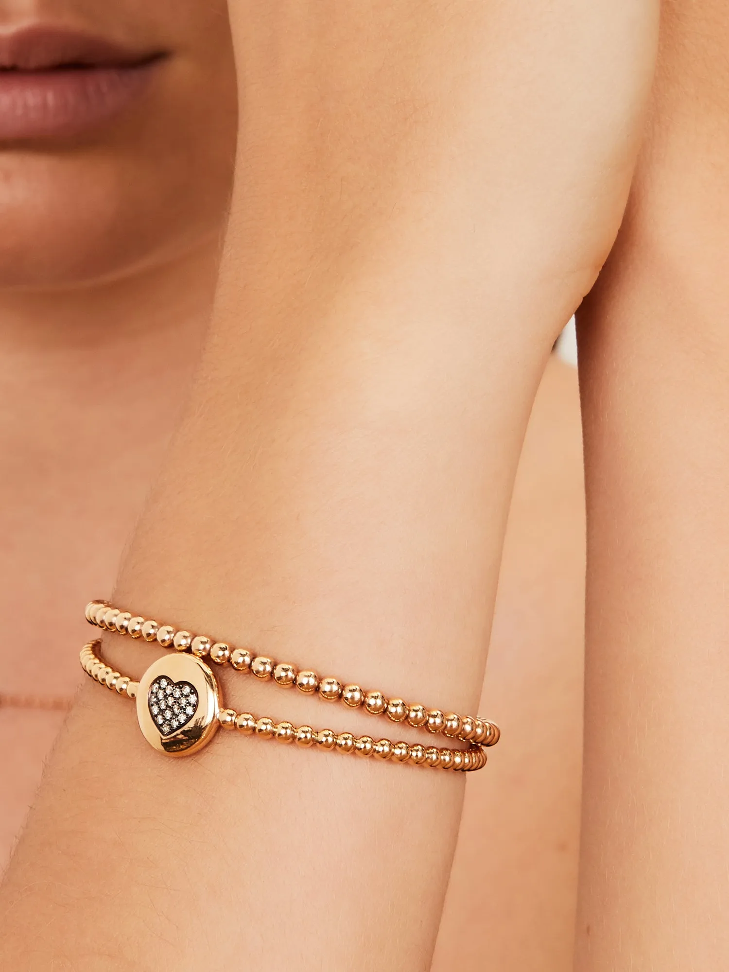 Rose gold stretch bracelet round charm with a diamond clover