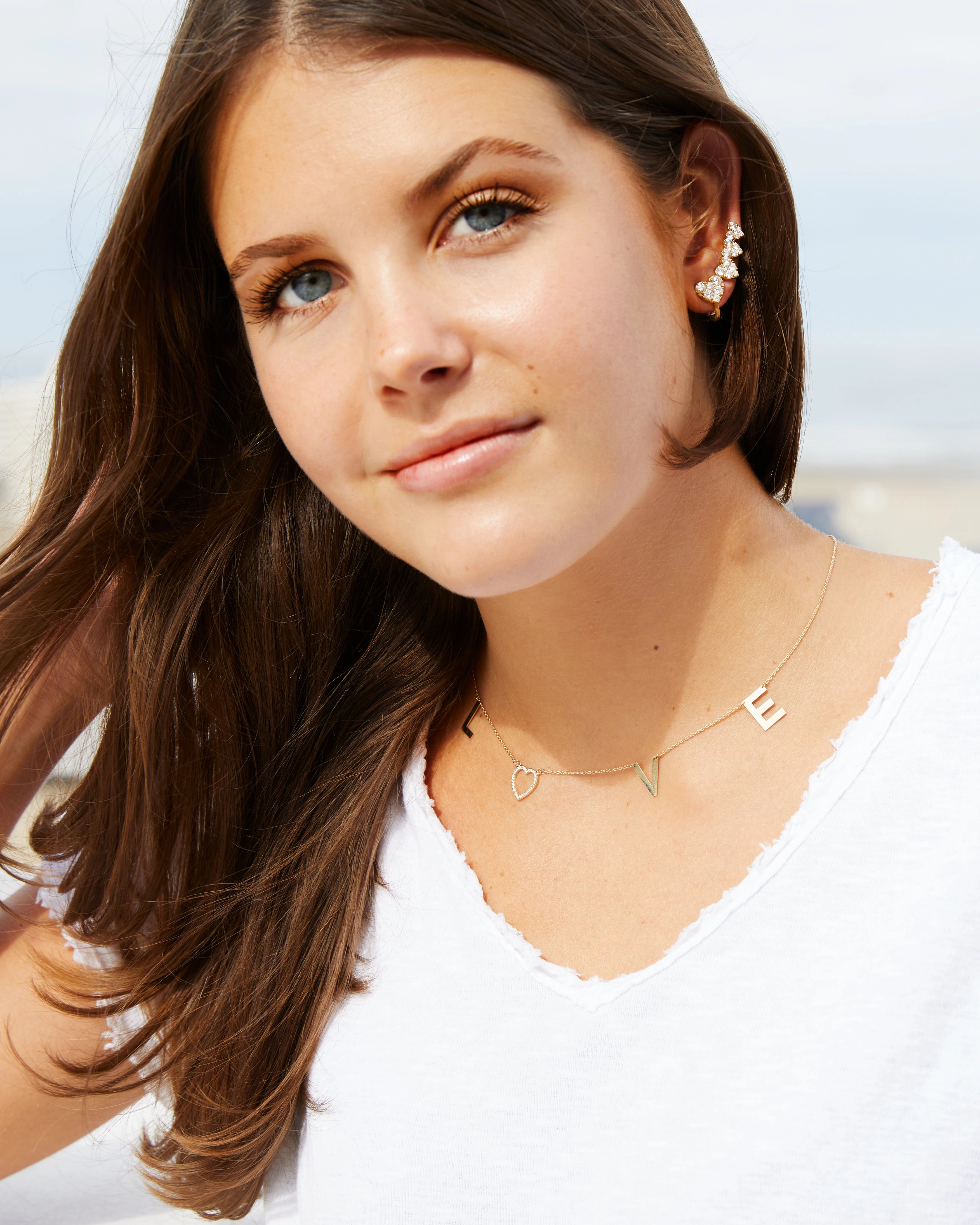 Yellow gold L-O-V-E necklace with a diamond heart